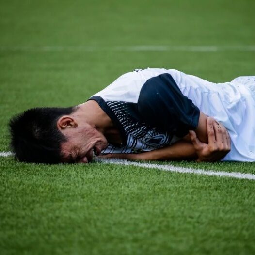 man crying on field with sport injury